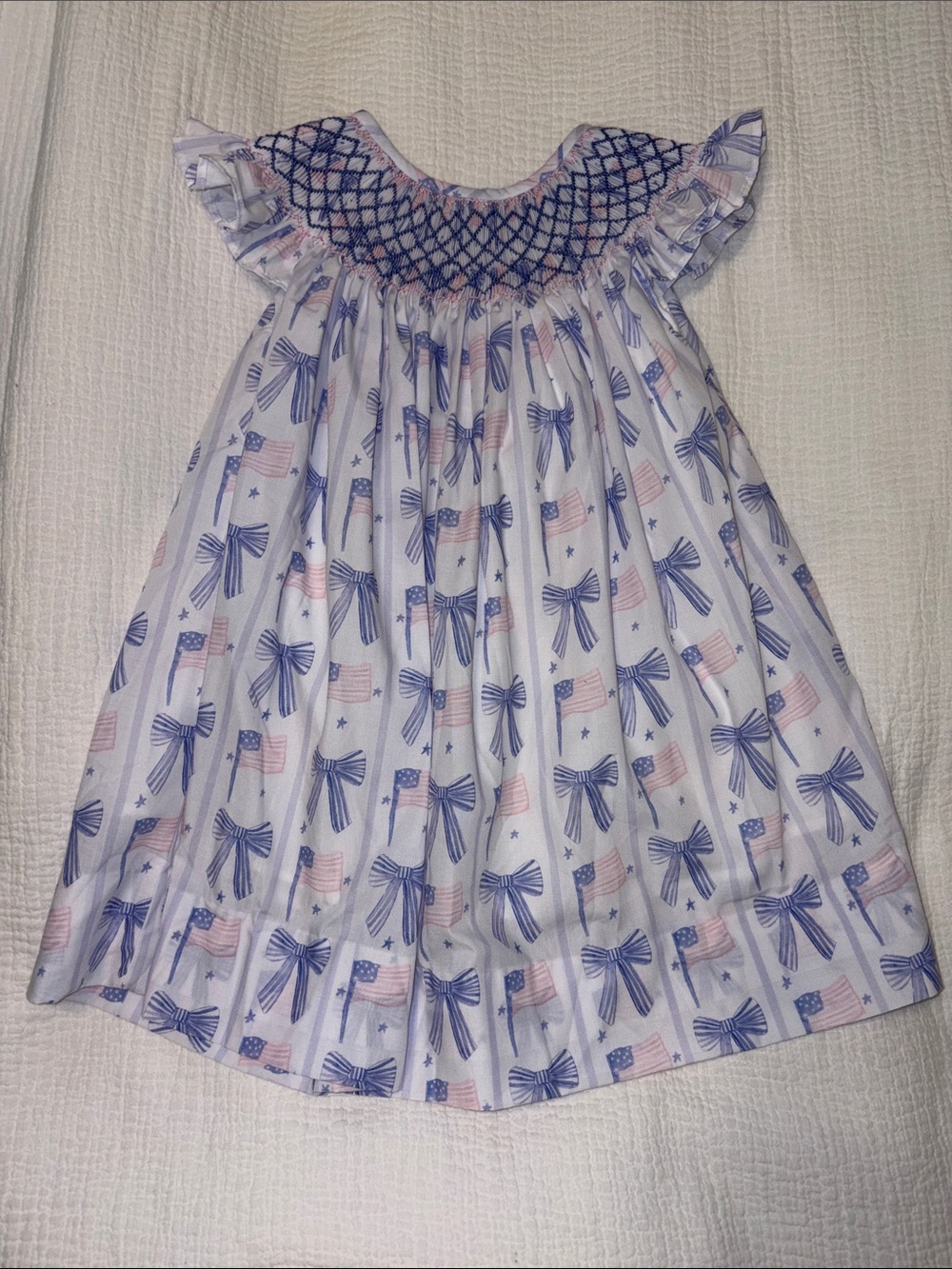 Girls White Dress with Blue Smocked Neckline and Flag Bow Print